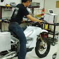 Neal Saiki on bike in Zero workshop
